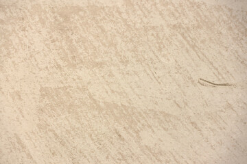 Mottled speckled tan, beige and brown close-up abstract textured background
