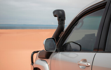 A powerful gray 4x4 SUV captured close-up in endless sands, ready for exploration and long desert expeditions.