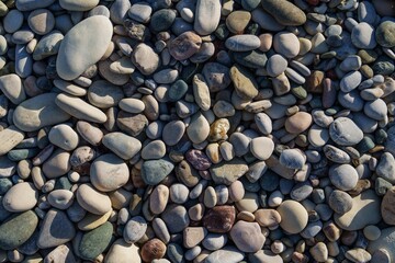 Discover the beauty of a pebble beach with vibrant, smooth stones. Ideal for backgrounds and...