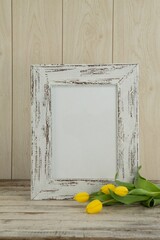 Photo frame and flowers on table