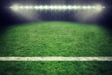 Grass sports field is glowing under stadium floodlights in flat design, showing white boundary line
