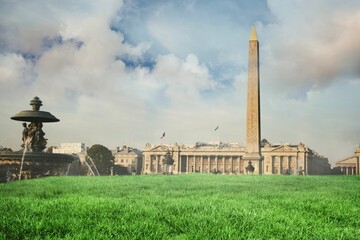 Luxor Obelisk is rising on green lawn in flat design, with fountain, columns, lampposts and flag