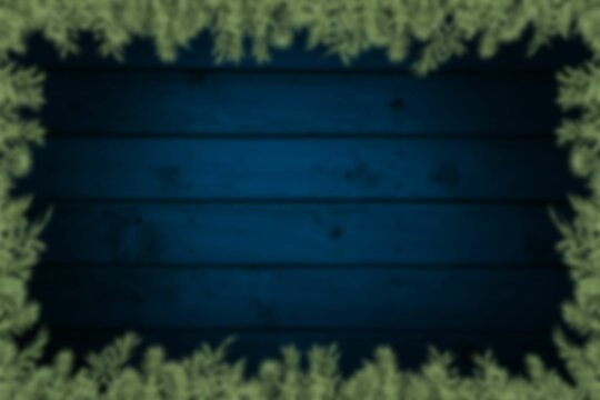 Fototapeta Blurred fir tree branches on wood