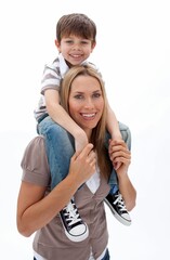 Smiling mother carrying son on shoulders