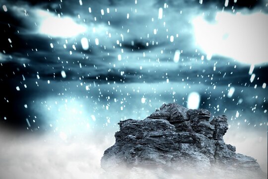 Fototapeta Large rock overlooking snowy sky