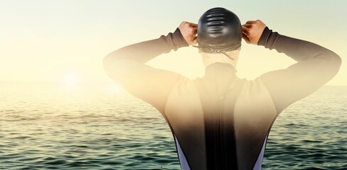 Rear view of swimmer against sea