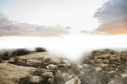 Fototapeta Flat illustration is showcasing arid rocky terrain with slabs, boulders, dry grasses and sun glare