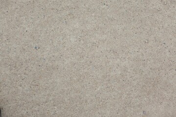 Close-up concrete texture is being shown in flat illustration, with tiny pebbles and earth tones