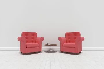 Red armchairs with table against wall
