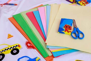 Rainbow, sun and clouds. DIY and children's creativity-crayons, colored paper, scissors