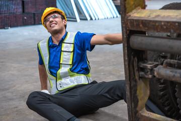 Male factory worker having accident from work in industry workplace