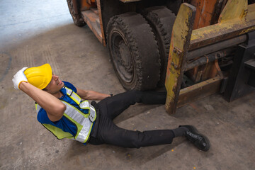 Male factory worker having accident from work in industry workplace