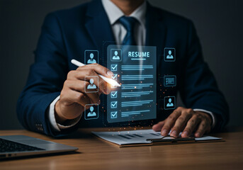 Businessman reviewing digital resume on tablet