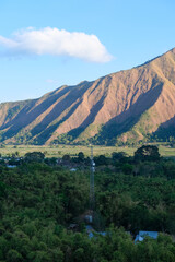 Majestic view of Pergasingan Hill glowing under soft morning light, seen from Selong Hill in Sembalun, Lombok—where dramatic ridgelines meet tranquil rural charm.
