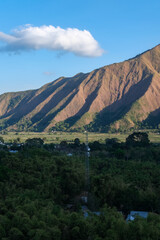 Majestic view of Pergasingan Hill glowing under soft morning light, seen from Selong Hill in Sembalun, Lombok—where dramatic ridgelines meet tranquil rural charm.