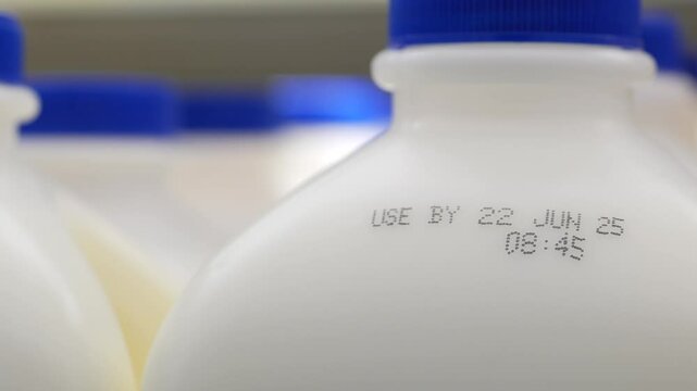 Milk bottles displayed with clear expiration dates