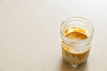 Cup of milk dirty coffee on table by the window.
