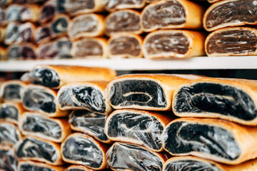 Walnut and poppy seed strudel rolled cake on street market