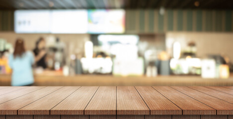 Empty wooden table top with lights bokeh on blur restaurant background.