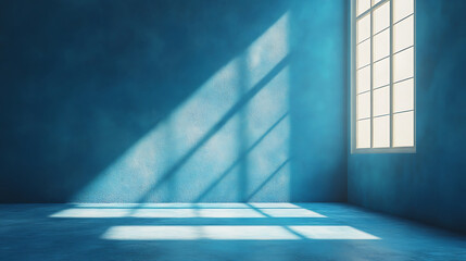 Empty blue room with light streaming through window showing abstract light patterns on wall and floor casting shadows creating serene interior space