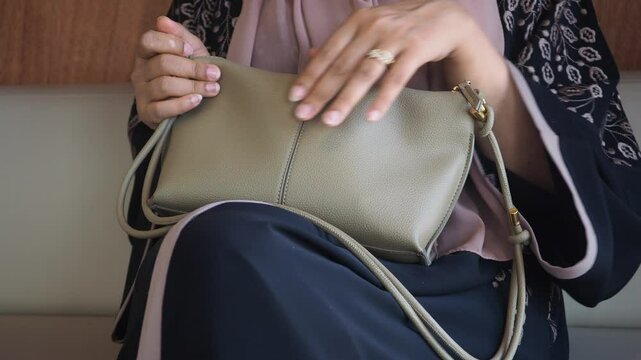 woman looking for something in her purse ,