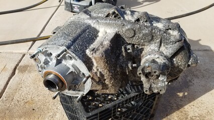 Cleaning a Transfer Case from a 1980s 4x4 SUV Sits on a Driveway 