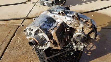 Transfer Case from a 1980s 4x4 SUV Sits on a Driveway 