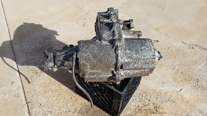 Transfer Case from a 1980s 4x4 SUV Sits on a Driveway 