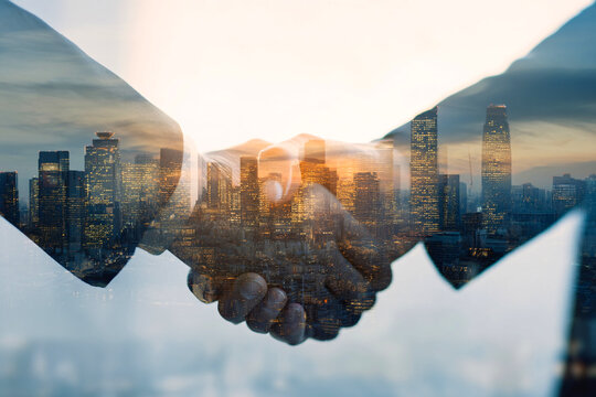business deal handshake with skyline background, negotiation, partnership and growth symbolism