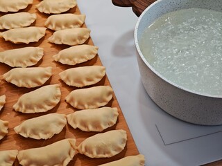 Handmade pierogi from grandma's recipe cooked in a pot of water