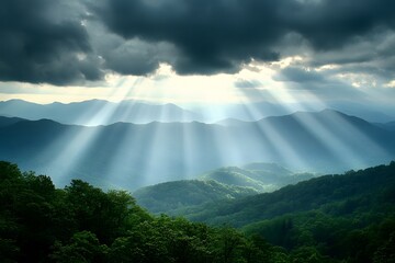 A panoramic view of the Mountains, with rays piercing through the clouds above, surrounded by lush greenery and forest-covered hills below. 