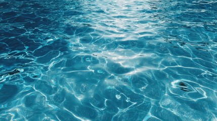 Sunlight dances on the surface of crystal-clear turquoise water creating mesmerizing patterns of light and shadow.