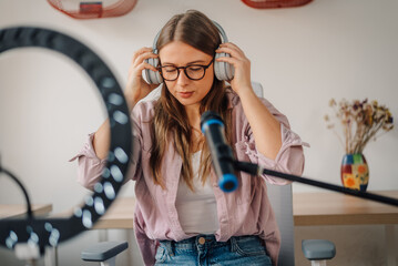 Content creator wearing headphones and preparing to record a podcast or video