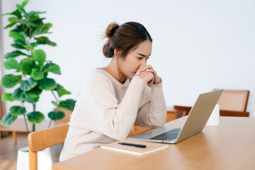 Thoughtful tired woman working on laptop computer looking on screen thinking solving problem at home office, serious woman search for inspiration make decision feel lack of ideas