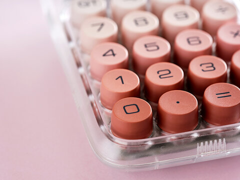 Modern Calculator with Round Pink Keys on Pink Background