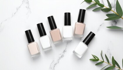 Obraz premium Neutral Nail Polish Collection with Natural Accents on Marble Surface