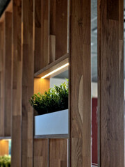 Luxurious wooden partitions in the interior dampen noise and designally break up the wall surface...