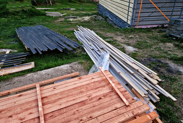 Carpenter built a log cabin with rough hewn beams. Planing wood. Authentic artisanal wooden log...