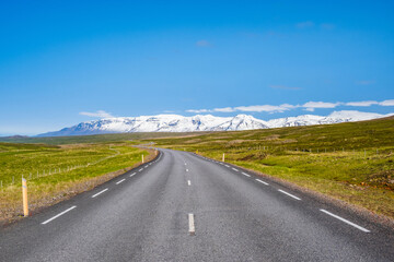 Road and snow covered mountains in North East Iceland
