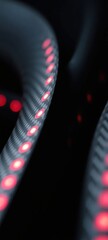 Abstract close-up of undulating black carbon fiber ribbons with embedded red LED strips