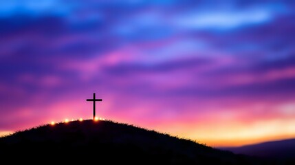 Fototapeta premium Silhouette of Christian cross on hilltop against dramatic purple and orange sunset sky with glowing clouds, spiritual and religious background concept.
