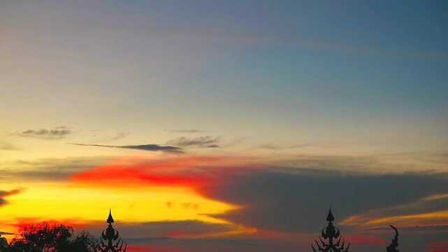 sunset red yellow orange sky and dark gray cloud over  silhouette fench