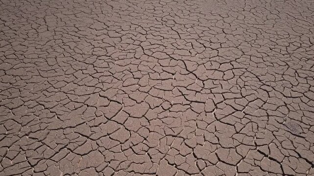  aerial of desiccated, cracked ground showing large-scale environmental drought, earth texture patterns, and the serious effects of desertification and climate instability