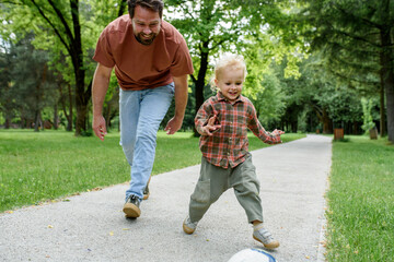 Father lining up to have a running race with his little son.