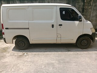 Car parked in yard under scorching sun 