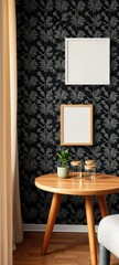 Interior scene with a round wooden table against a black botanical wallpaper