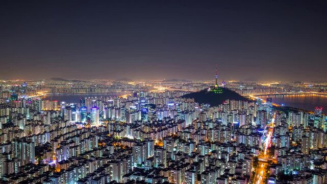 Dazzling panoramic aerial view of sprawling modern city at night with glowing skyscrapers and traffic lights, symbolizing urban development, infrastructure, megacity lifestyle, and night photography o