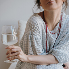 Woman Relaxing with Glass of Water at Home