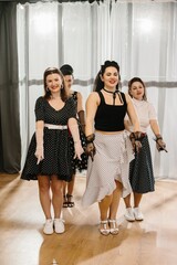 Pinup dancers showing rock and roll moves in 1950s style dance class