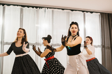 Pinup dancers wearing polka dots are performing a choreography
